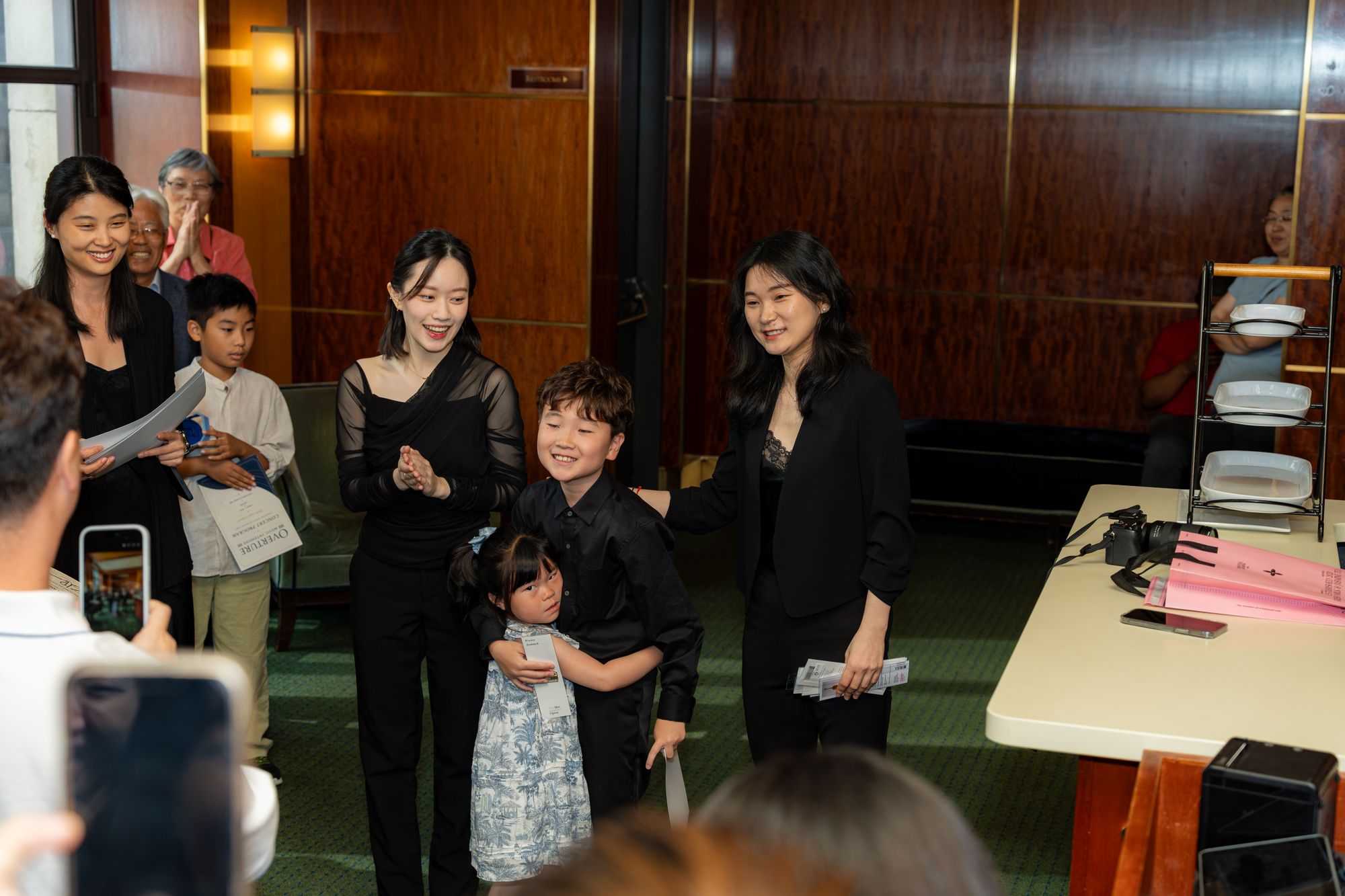 Students and faculty share a laugh at the post-concert reception