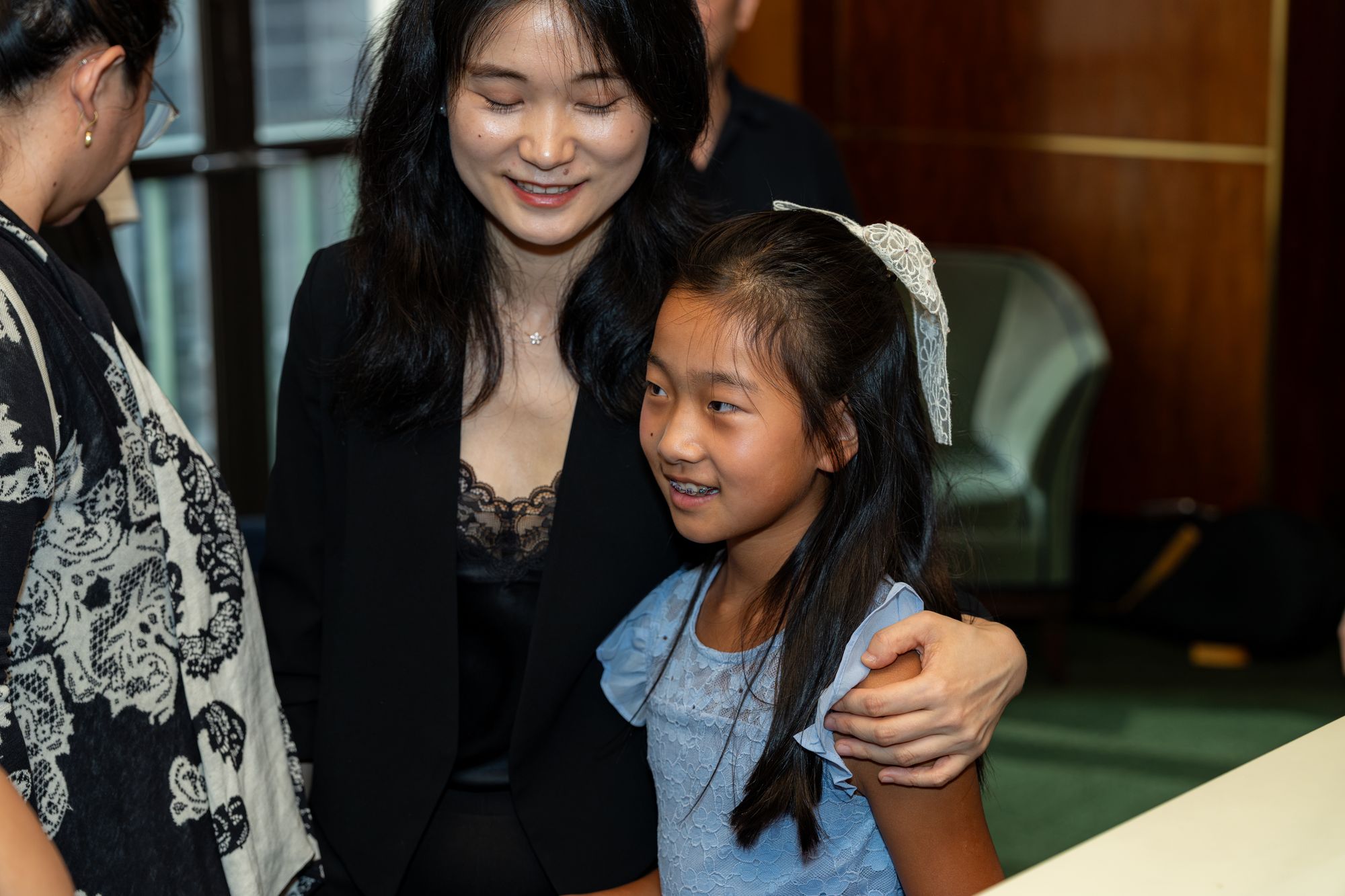 A faculty member and student embrace after the final concert
