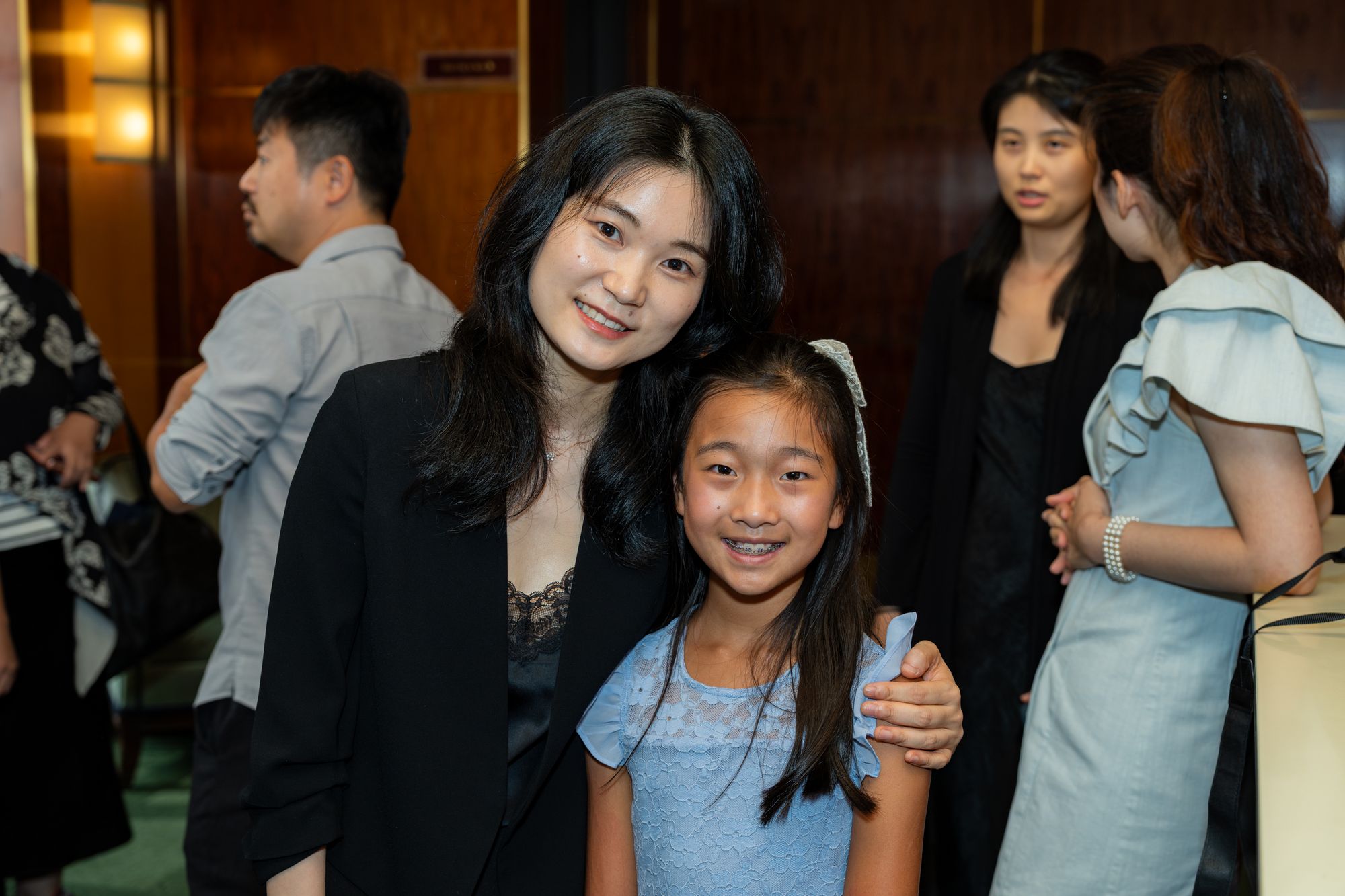 A faculty member and student smile together at the reception