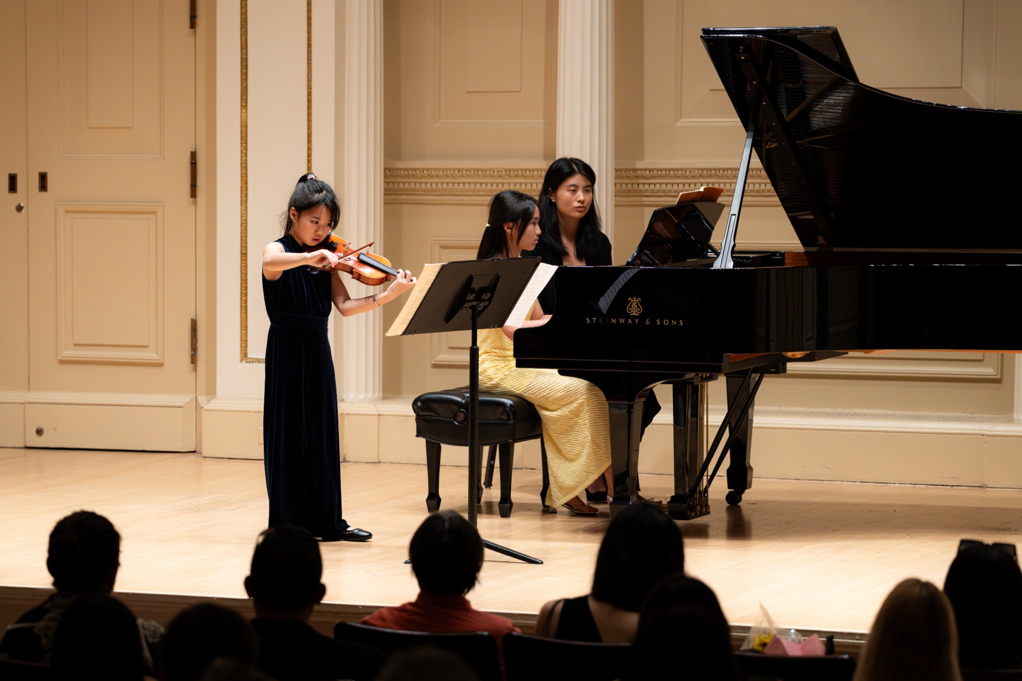 A young violinist performs with a pianist at Weill Recital Hall