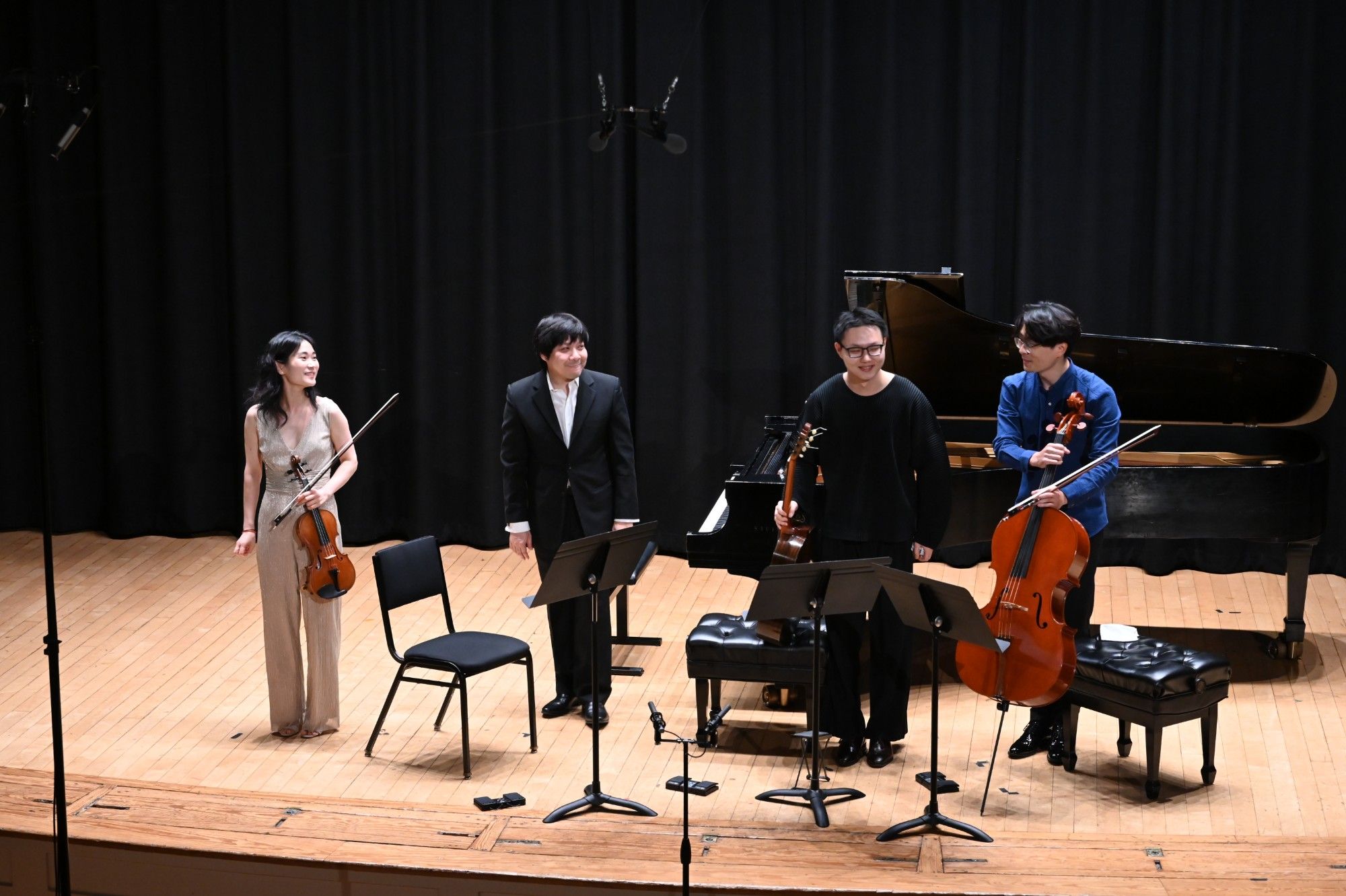 The four performers share a smile on stage after the quartet