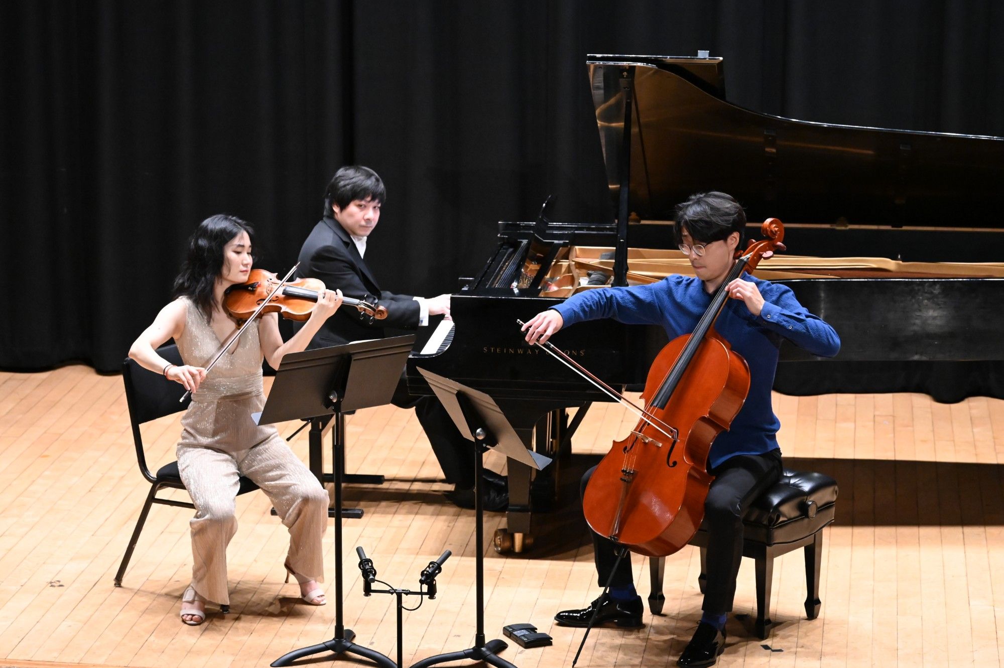 Yinfei Wang watches his partners as the trio plays