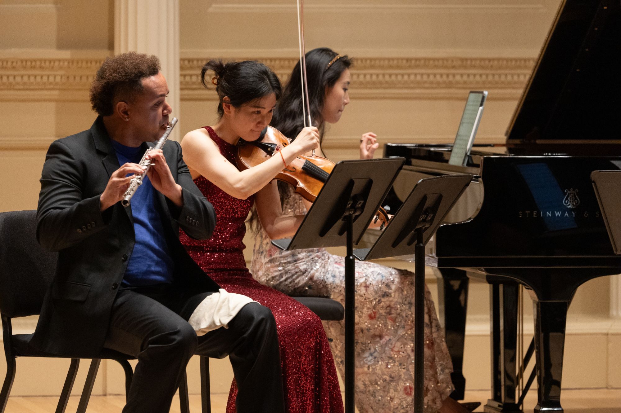 Flutist and violinist in close-up during a new work