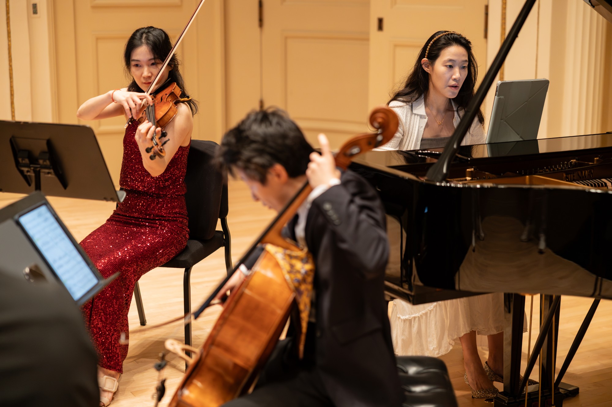 Violinist, cellist, and pianist during a premiere at Weill Recital Hall