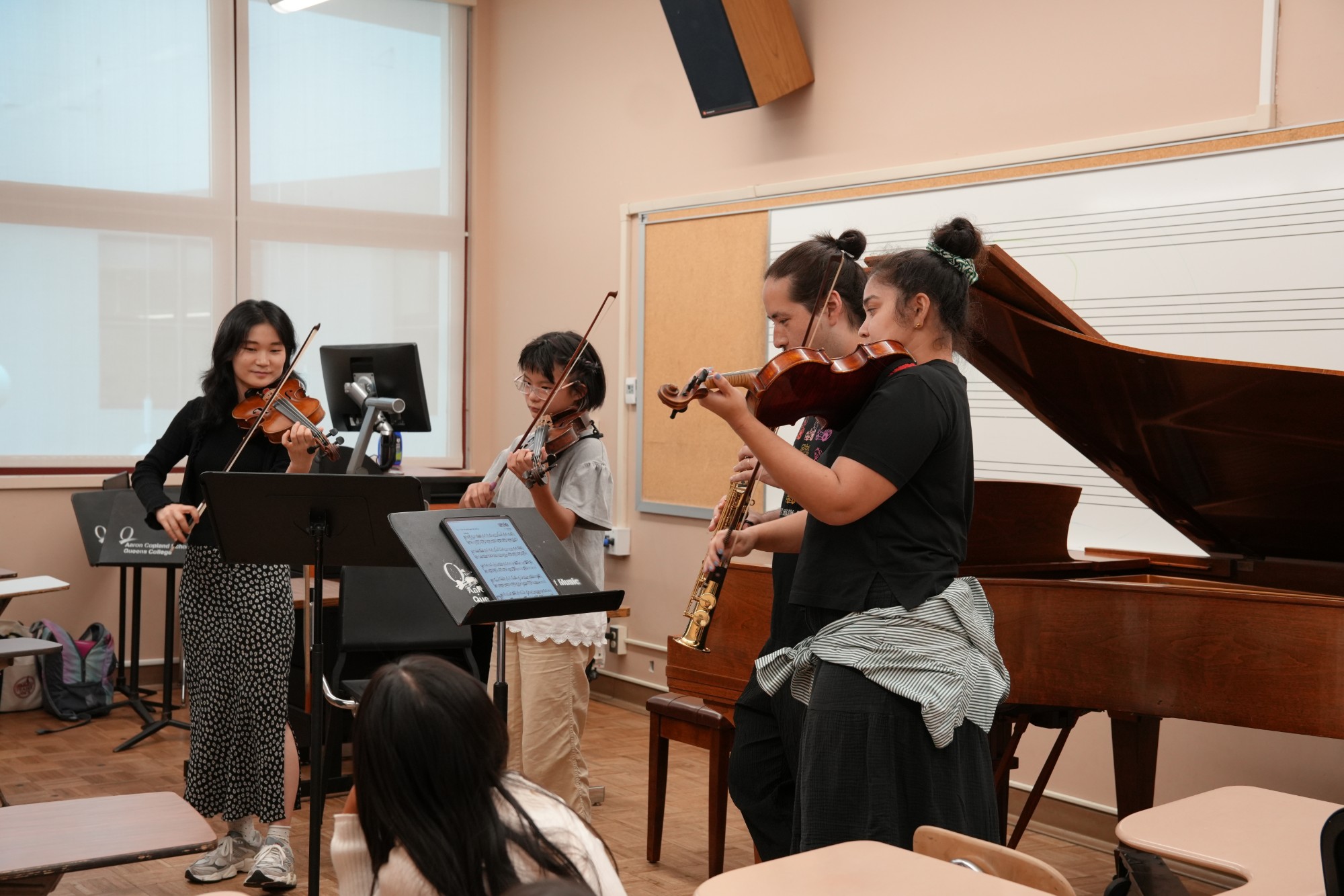 Musicians read chamber music together in a relaxed session