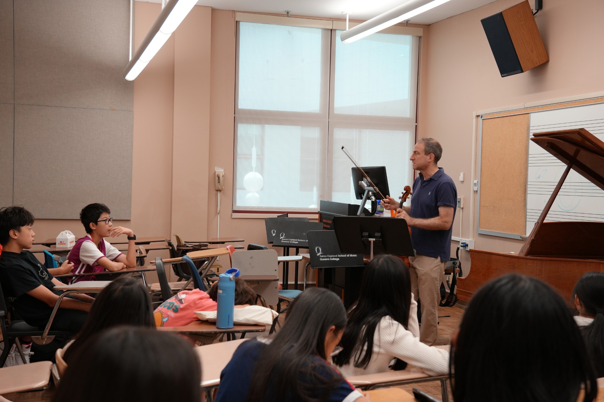 An OMI artist leads a workshop for young musicians